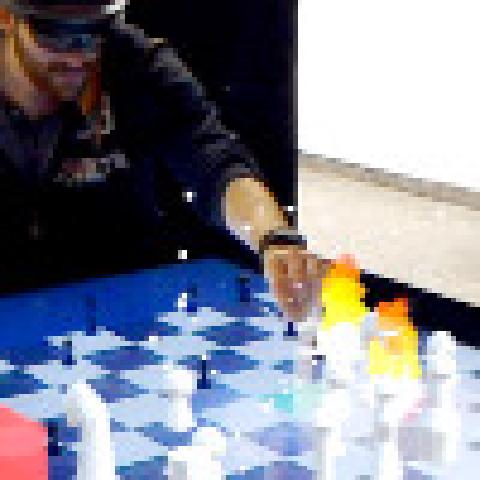 CheckMate: Exploring a Tangible Augmented Reality Interface for Remote Interaction