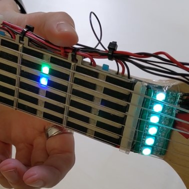 Let's Frets! Mastering Guitar Playing with Capacitive Sensing and Visual Guidance
