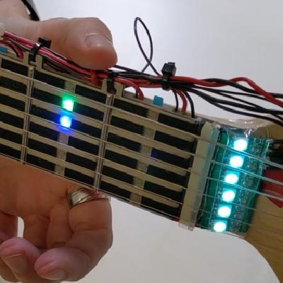 Let's Frets! Mastering Guitar Playing with Capacitive Sensing and Visual Guidance